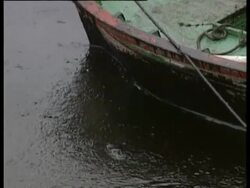 Prow of rowing boat in thick oil slick. La Coruna, Spanish Mediterranean, Urquiola spill, May 1976. Stock Footage