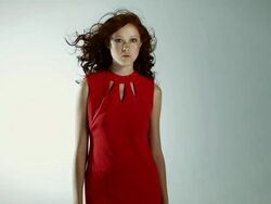 Young woman wearing red dress with windswept hair Stock Footage