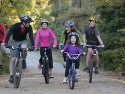 TS Parents and Children Riding Bikes Together on Path in Woods / Richmond, Virginia, USA Stock Footage