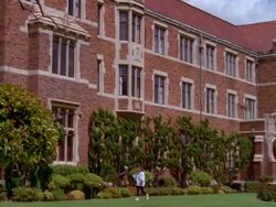 WS TU View of 3rd floor windows on tower of red brick high schoo and female student walking / Los Angeles, California, United States Stock Footage