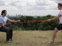Male and personal trainer exercise in park Stock Footage
