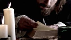 Nostradamus reads a book by candlelight. Stock Footage