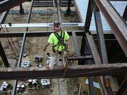 A steelworker grabs a swinging beam Stock Footage