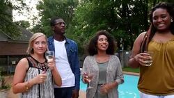 MS Laughing group of friends hanging out by backyard pool on summer evening Stock Footage