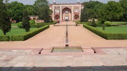 View of the entrance portal into Humayun's Tomb and the landscaped Charbagh garden, along with visitor's, as seen from the Tomb itself Stock Footage