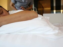 Dolly shot: Woman Relaxing While Getting Body Massage Stock Footage