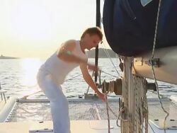 HD: Operating Sail Winch While Sailing At Sunset Stock Footage