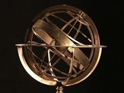 Metal rings surround the central orb of an armillary sphere. Stock Footage