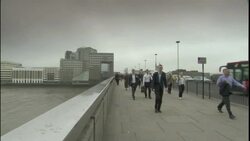 Pedestrians stroll across a footbridge over River Thames near Tower Bridge in London, England. Stock Footage