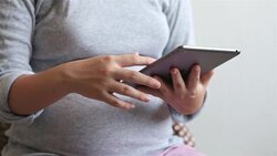 Pregnant woman using a tablet Stock Footage