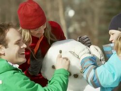 Family builds a snowman togther Stock Footage