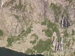 WS AERIAL View of waterfall from mountain rock / Wyoming, United States Stock Footage