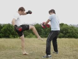 Two male box training in park Stock Footage