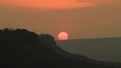 Sunrise through flowing cloud waves, mountain Stock Footage