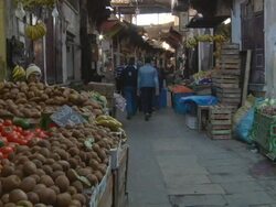 MS Shot of vegetable shop and people walking in downtown / Fes, Centro-North, Morocco Stock Footage