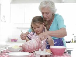 Grandmother And Granddaughter Baking In Kitchen Stock Footage