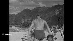 1936: HITLER-JUGEND INTO LABOR SERVICE: Young Nazi adult lifting poles for exercise, teamwork. VS Young adult Nazi labors swinging weights, using pitch forks, wheel barrows, shovels on sod. Instructional Video