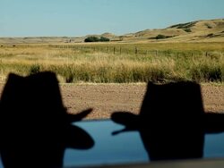 A landscape in the prairies with two cowboys hats on a hood Stock Footage