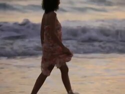 Good Looking Young Couple embracing in front of the Sea at sunset Stock Footage