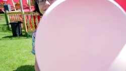 Boy holding balloons in amusement park Stock Footage