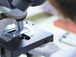 female scientist use microscope working in lab Stock Footage