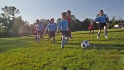 Children playing soccer Stock Footage
