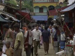 Medium Shot - People walking through and stopping at various vendors in open air street market / Bangladesh  Stock Footage