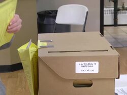  CU Shot of woman deposits provisional ballot in ballot box when voting at UAW hall / Toledo, Ohio, United States Stock Footage
