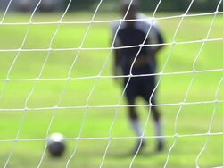A man playing soccer on a grassy field. - Slow Motion - filmed at 240 fps Stock Footage