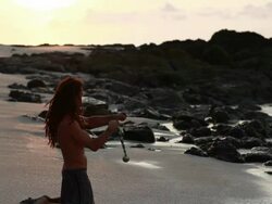MS TU TD Rasta man doing yoga moves and spinning poi balls on beach with ocean / Montezuma, Punteranes, Costa Rica Stock Footage