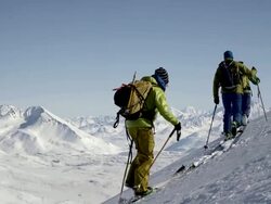 SLOW-MO: Men Ski Tour In Vastness Of Alaska Stock Footage