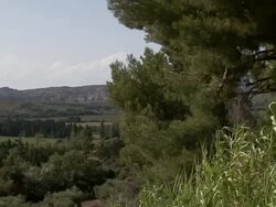 Grass grows on a hill above a pretty French countryside. Stock Footage
