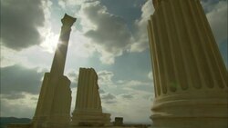 Sun rays beam behind columns at the Oudna Amphitheater ruins on a cloudy day in Tunisia. Stock Footage