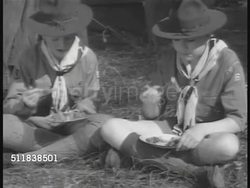 1940: THE US BOY SCOUTS: Scouts cooking over campfire, eating food outside, WS Scouts rowing canoes, beating out bush fire. MS Boy Scout using drill press in workshop.  Leadership, Service, Personal fitness, Merit Badges. Instructional Video