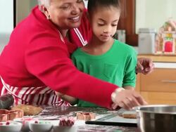 MS TD Grandmother and Granddaughter Baking Gingerbread Men Cookies in Kitchen / Richmond, Virginia, USA Stock Footage