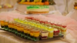 MEDIUM SHOT PANNING Desserts, cakes and fruit arranged for party Stock Footage