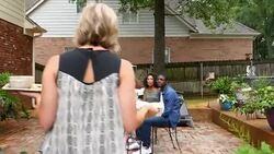 MS TS Woman carrying appetizer out to table while hanging out with friends during backyard party Stock Footage