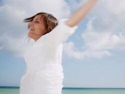 Woman spinning on beach Stock Footage