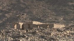 Desert hills surround the ruinous city of Shenshef, Egypt. Stock Footage