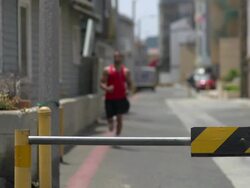 A man working out in an urban alley, doing shoulder press with a road barricade bar. - Slow Motion Stock Footage