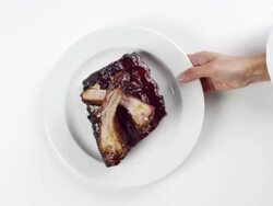 CU Woman hand entering setting down round white plate with BBQ ribs dinner / Omaha, Nebraska, United States Stock Footage