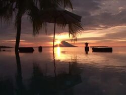 MS ZI Shot of Sunset behind volcano / Bunaken National park, Sulawesi Island, Indonesia    Stock Footage