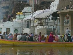 MS SLO MO Pilgrims in boat passing by ghats / Varanasi, Uttar Pradesh, India Stock Footage