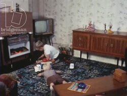 Somewhere Decent to Live 1967 part 9 - boys playing in living room, mother puts them in the bath, gets ready for bed Stock Footage