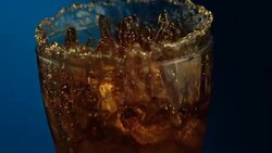 Beverage splash on blue background Stock Footage