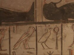 Close Up, tilt-up - A mural depicts Egyptian figures and hieroglyphics Stock Footage