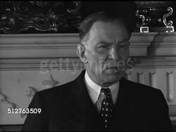 1944: LONDON, ENGLAND: Lord Robert Vansittart (1881-1957) standing by fireplace saying First World War cost 25 Million lives, before second through may cost three or four times as much, disease is national & cure must be national. Instructional Video