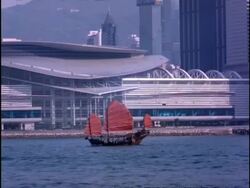 MS Chinese Junk moving in front of conference centre, Hong Kong Stock Footage
