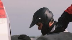 Stock car pit-crewman rolls, changes race-car tire Stock Footage