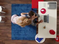 MS, Lockdown, woman standing behind her man while he works in his home office, overhead view Stock Footage
